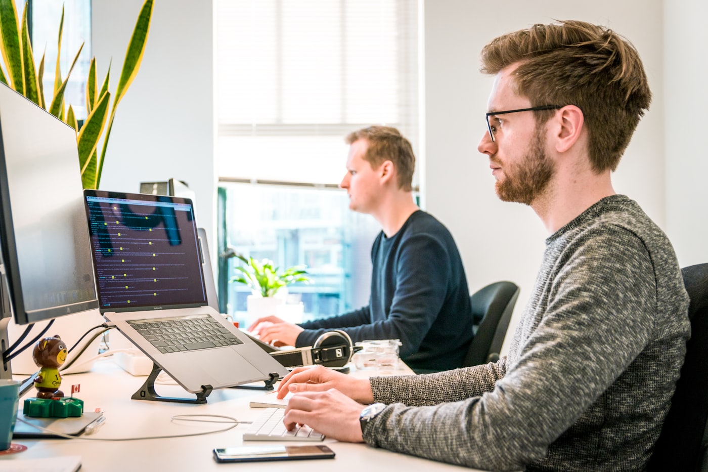 Product team collaborating around a laptop